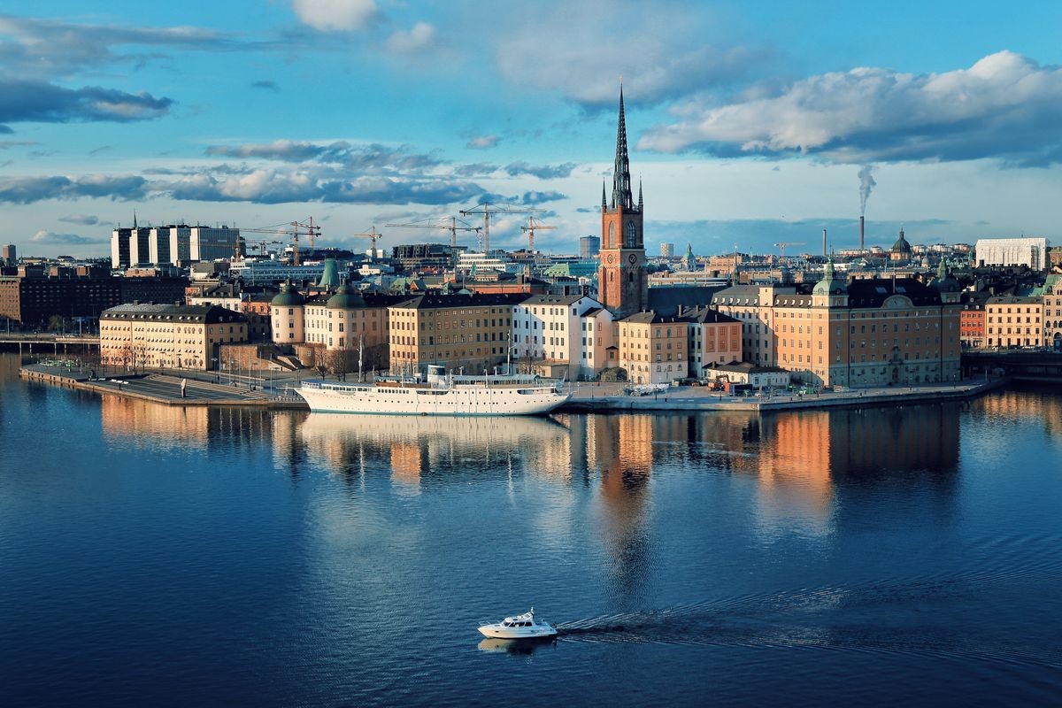 Scenic of the Old Town (Gamla Stan) architecture in Stockholm, Sweden with boat in the river.